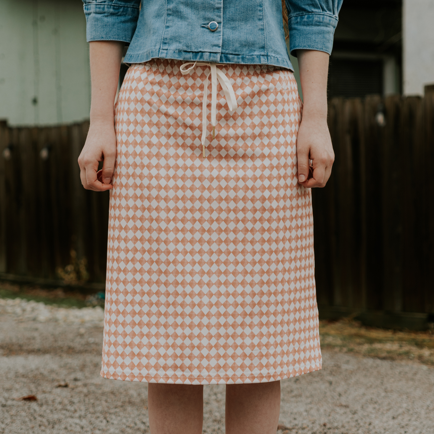 Person wearing a checkered skirt with a blurred background