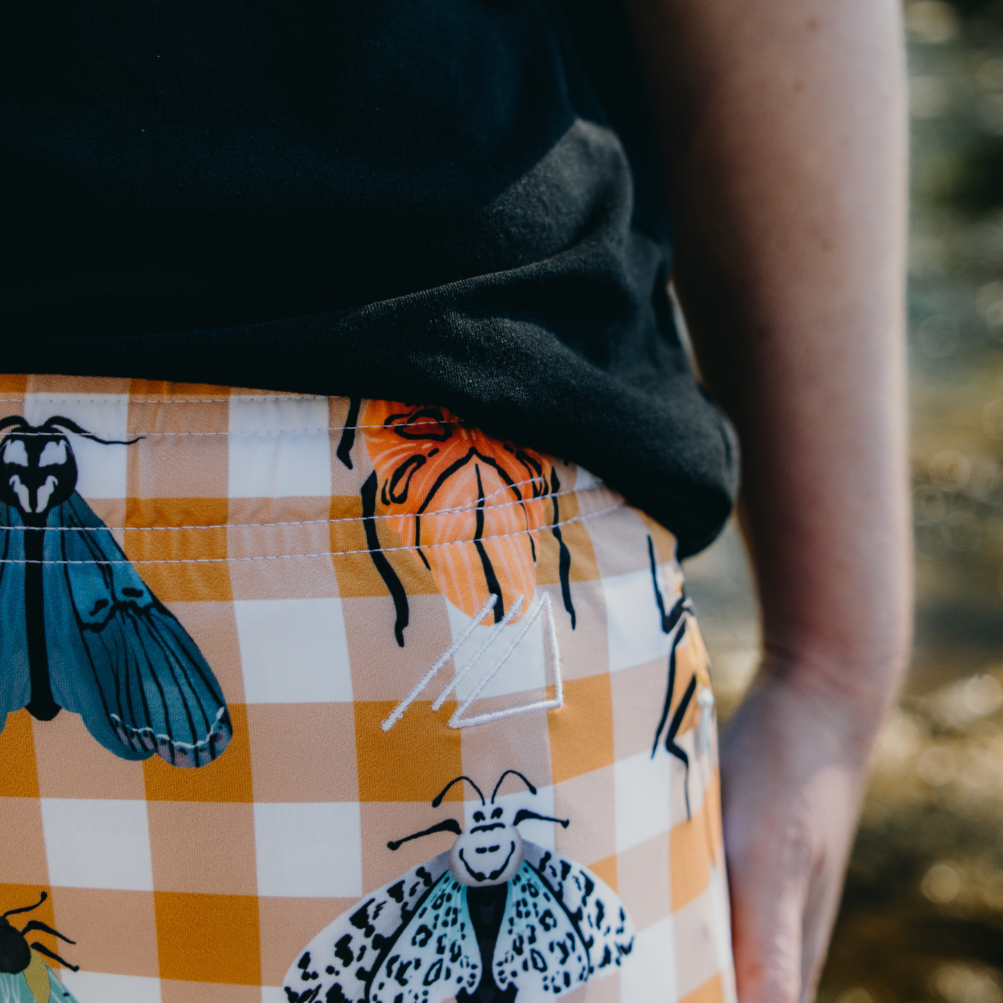 
                  
                    Person wearing a skirt with butterfly patterns in an outdoor setting
                  
                