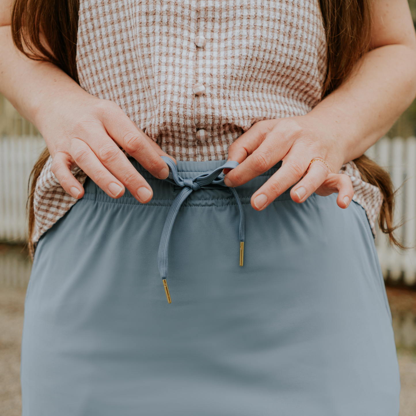 
                  
                    Person wearing a blue skirt with a blurred background
                  
                
