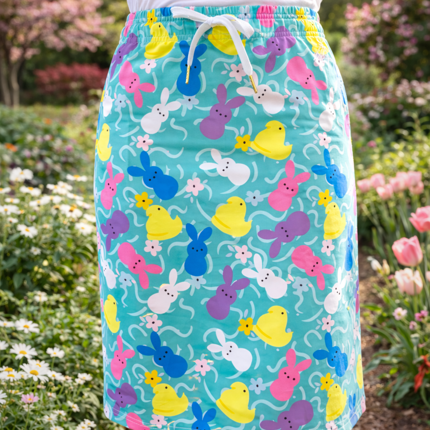 
                  
                    Colorful skirt with bunny and duck pattern worn by a person in a garden setting
                  
                
