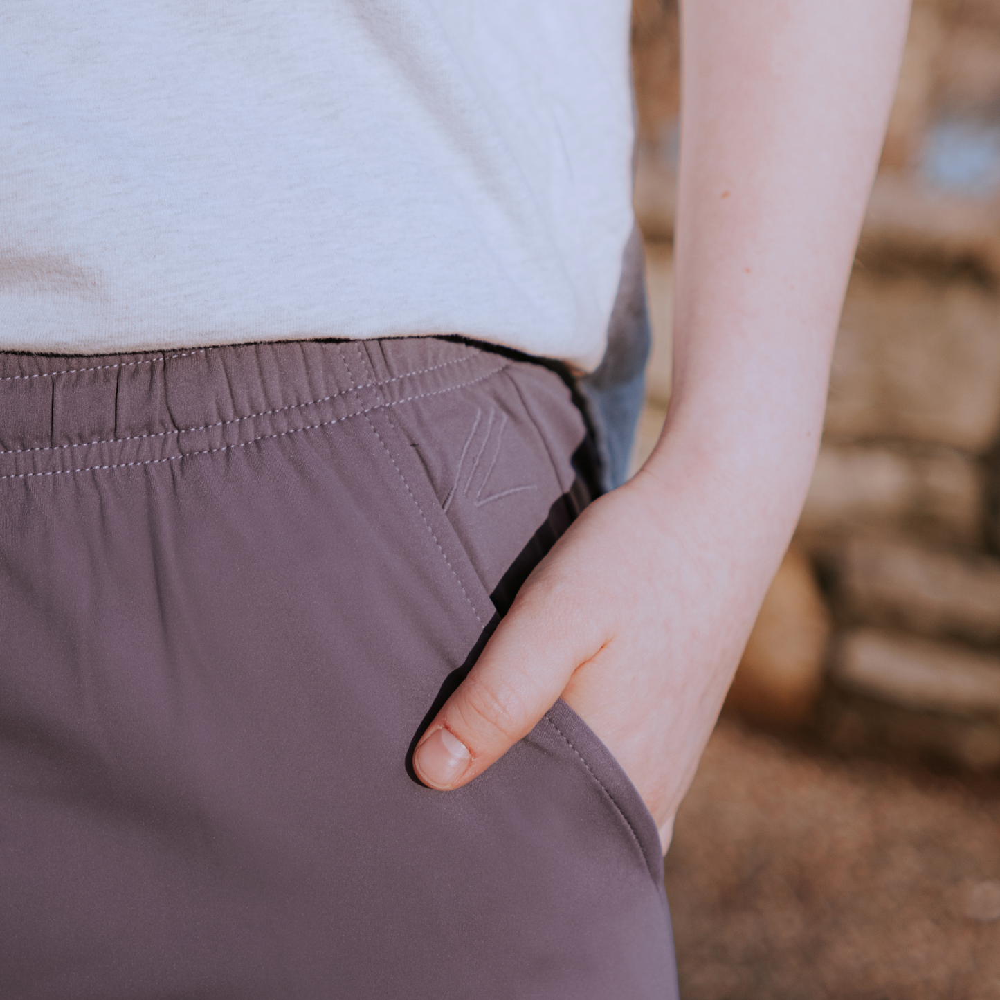 
                  
                    Person wearing purple skirt with a blurred background
                  
                