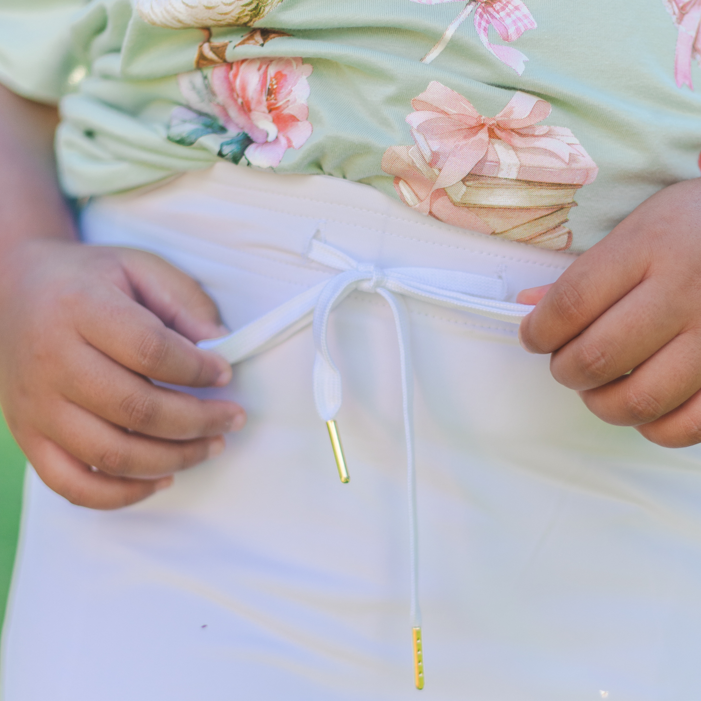 
                  
                    Close-up of a kid tying a drawstring on a skirt
                  
                