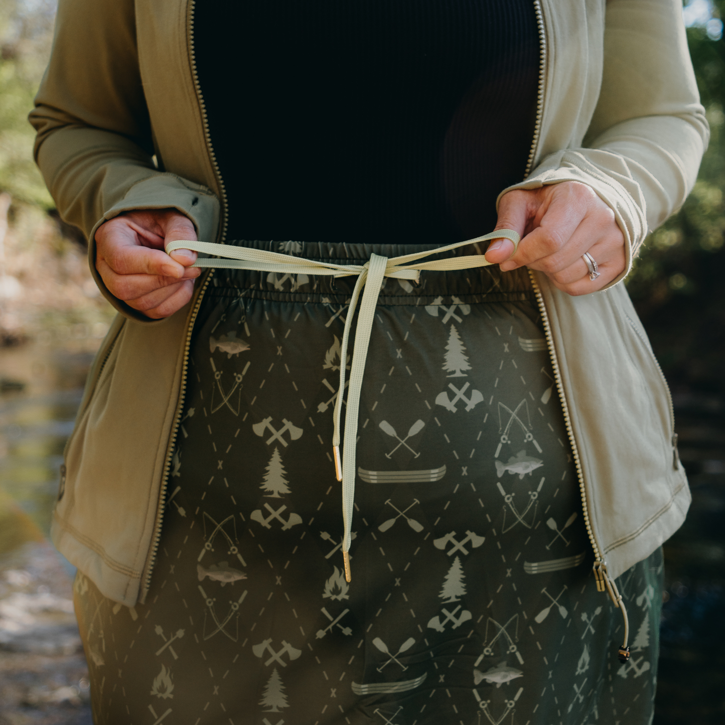 
                  
                    Person wearing a patterned skirt with a blurred natural background
                  
                